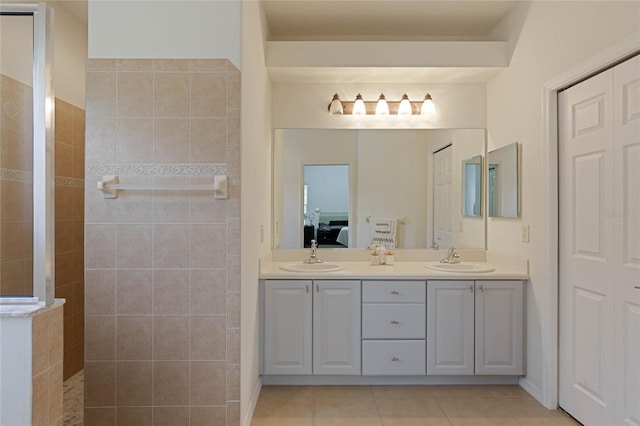 full bath featuring tile patterned flooring, ensuite bath, walk in shower, and a sink