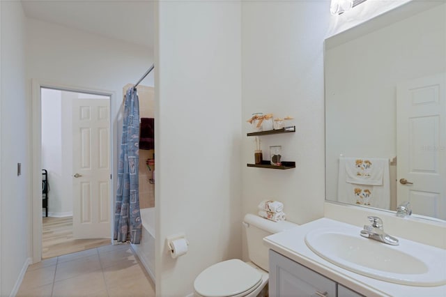 bathroom featuring tile patterned flooring, baseboards, toilet, shower / tub combo with curtain, and vanity