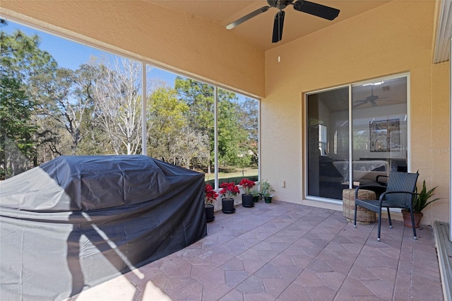 view of patio with a grill and a ceiling fan