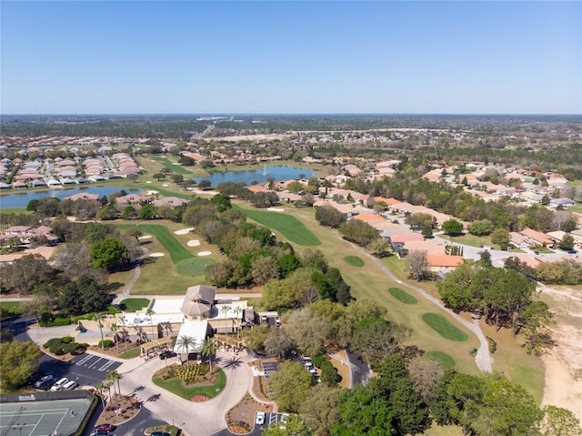 birds eye view of property with a water view and view of golf course