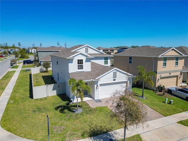 traditional-style home with a residential view, stucco siding, a garage, and fence