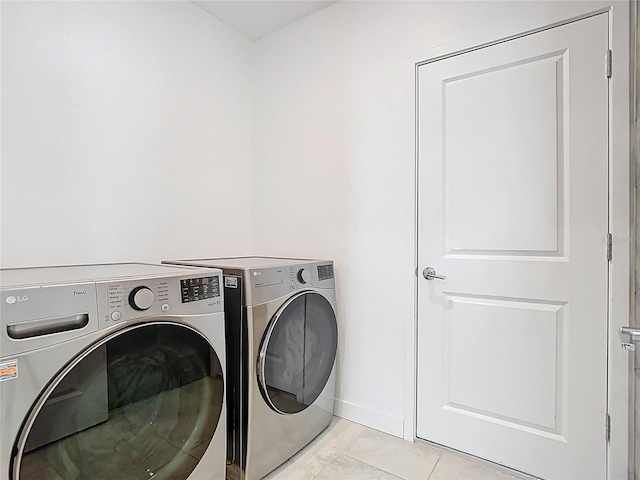 laundry area featuring baseboards, separate washer and dryer, and laundry area