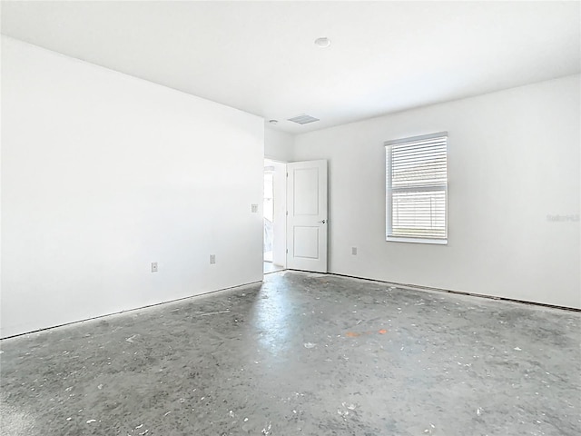 unfurnished room with visible vents and concrete floors