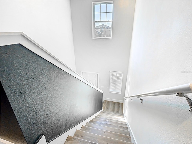 stairway with wood finished floors