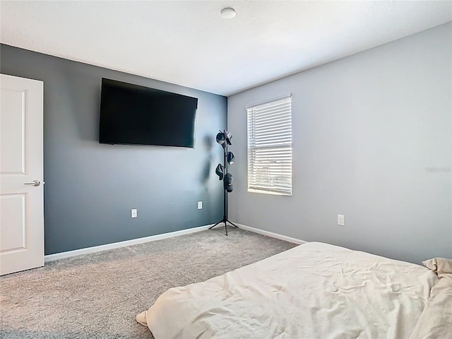 bedroom featuring carpet and baseboards