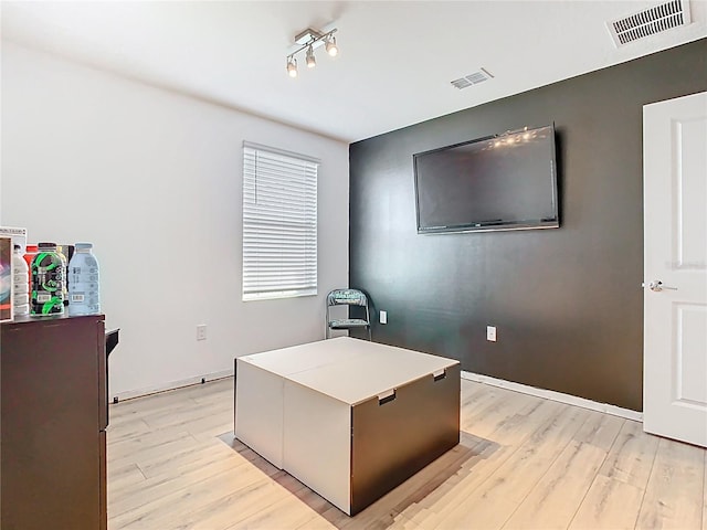 office with visible vents and light wood-style flooring