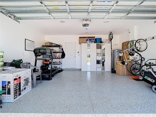 garage with a garage door opener and water heater