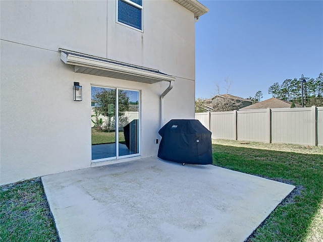 view of patio / terrace featuring grilling area and fence