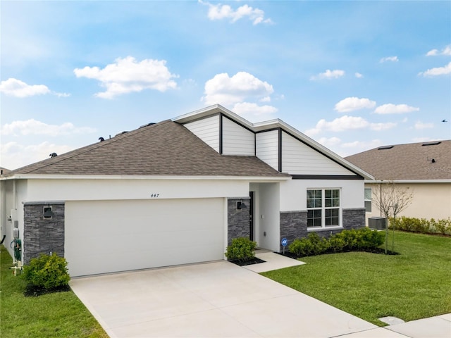 view of front of property featuring stone siding, roof with shingles, concrete driveway, and a front yard