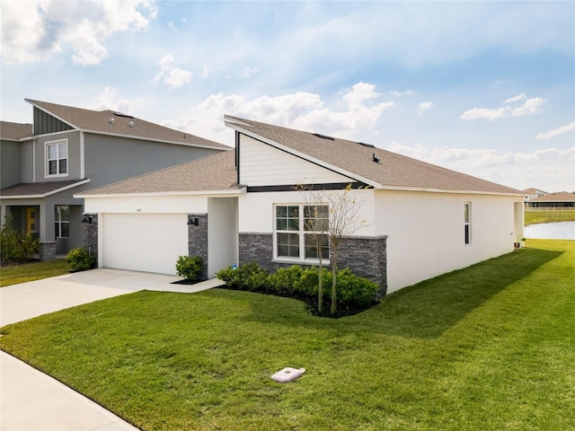 view of front of property with stucco siding, driveway, a front lawn, and an attached garage