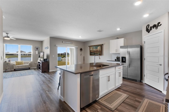 kitchen featuring a sink, white cabinets, an island with sink, and stainless steel appliances