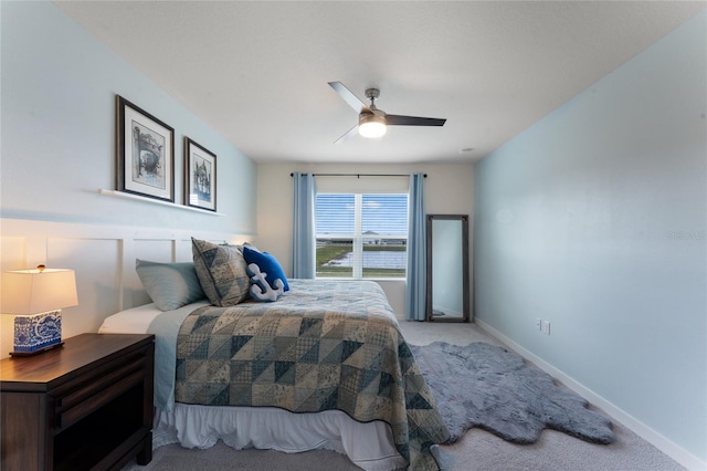 carpeted bedroom with a ceiling fan and baseboards