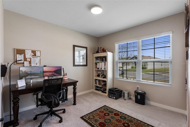 carpeted office space with baseboards