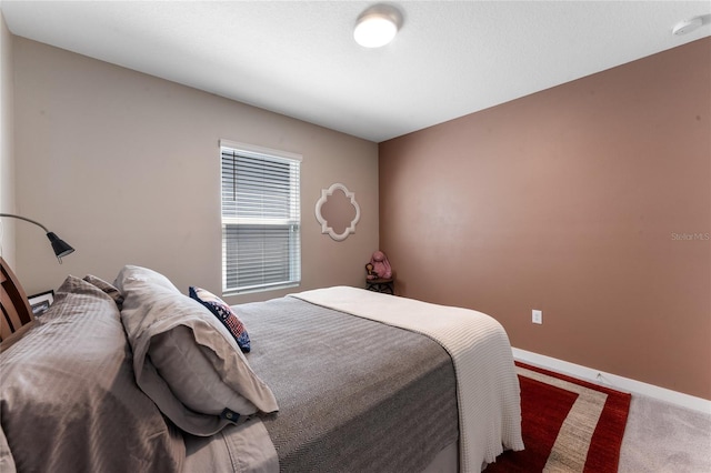 bedroom featuring baseboards and carpet floors