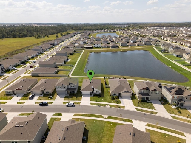 drone / aerial view featuring a residential view and a water view