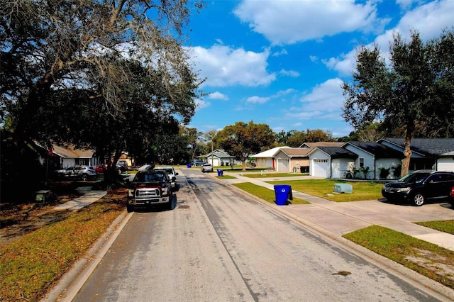 view of road featuring a residential view, curbs, and sidewalks