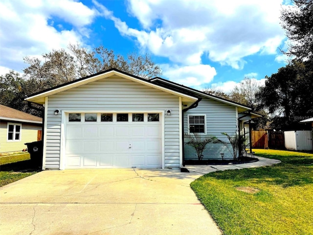 garage featuring driveway and fence