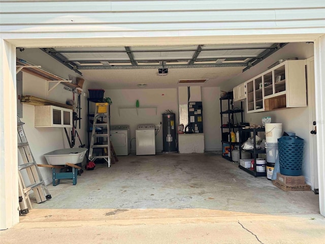 garage with washer and clothes dryer, heating unit, and electric water heater