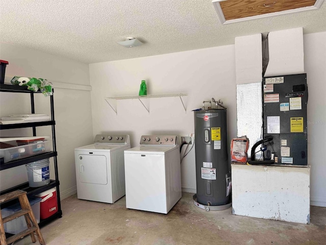 laundry area featuring water heater, laundry area, independent washer and dryer, and a textured ceiling