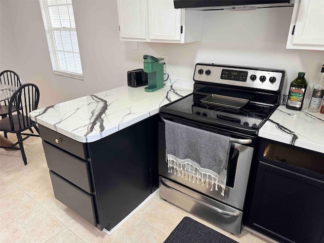 kitchen featuring ventilation hood, light tile patterned floors, a peninsula, stainless steel electric range, and white cabinetry