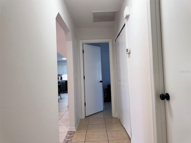 hallway with light tile patterned floors and visible vents