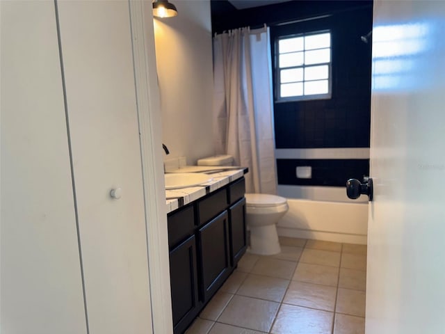 bathroom featuring vanity, tile patterned floors, shower / tub combo, and toilet