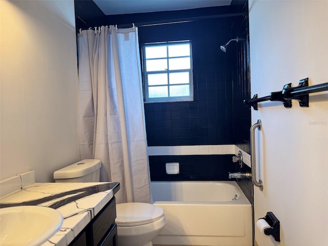 bathroom with toilet, vanity, and shower / tub combo