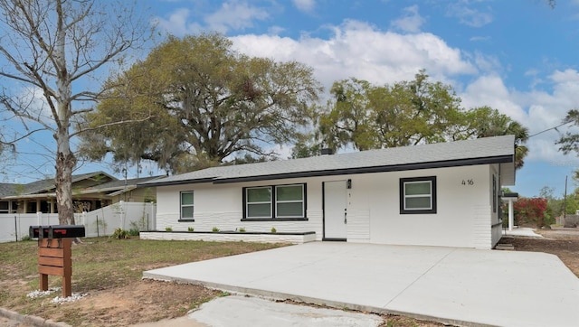 single story home with a patio and fence