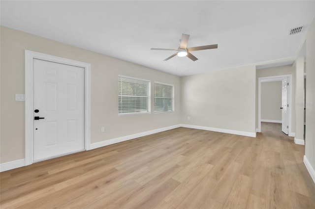 interior space featuring visible vents, baseboards, light wood-type flooring, and ceiling fan