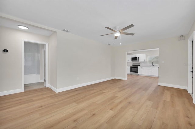 unfurnished living room with visible vents, a ceiling fan, light wood-style floors, and baseboards