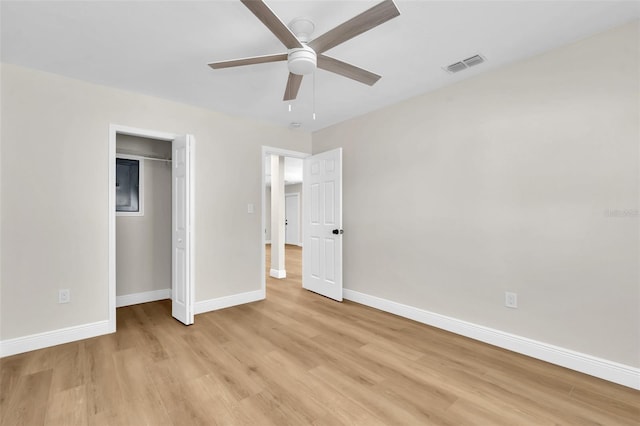 unfurnished bedroom featuring a closet, visible vents, light wood-style floors, and baseboards