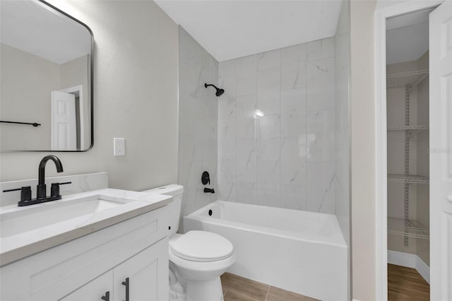 full bathroom featuring tub / shower combination, toilet, vanity, and wood finished floors