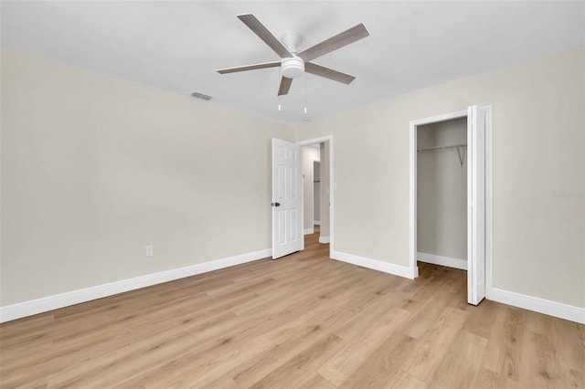 unfurnished bedroom featuring visible vents, a ceiling fan, a closet, light wood finished floors, and baseboards