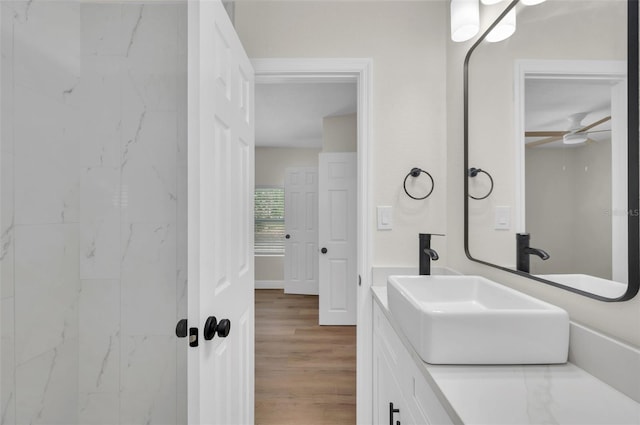 bathroom with vanity, wood finished floors, and ceiling fan