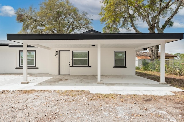 view of front of property with concrete block siding and fence