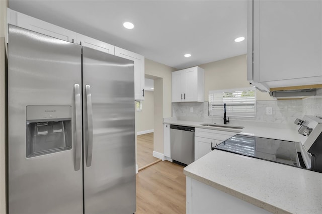 kitchen with tasteful backsplash, plenty of natural light, stainless steel appliances, and a sink