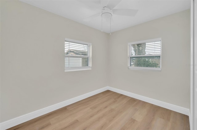 unfurnished room with light wood finished floors, a ceiling fan, and baseboards