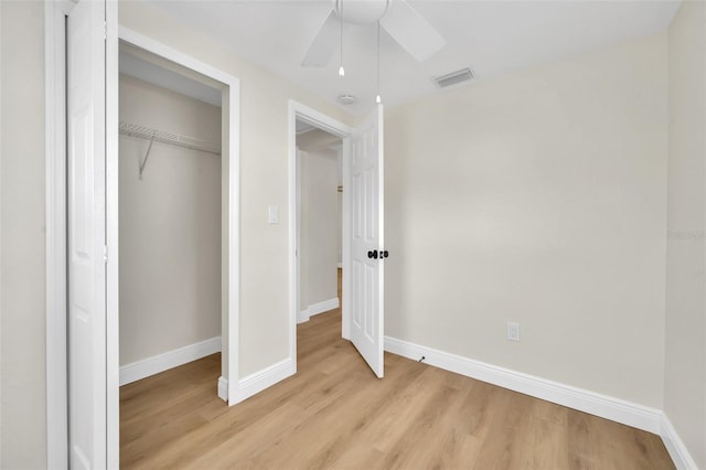 unfurnished bedroom with visible vents, baseboards, a closet, and light wood finished floors