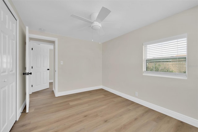 unfurnished bedroom featuring a closet, baseboards, ceiling fan, and light wood finished floors