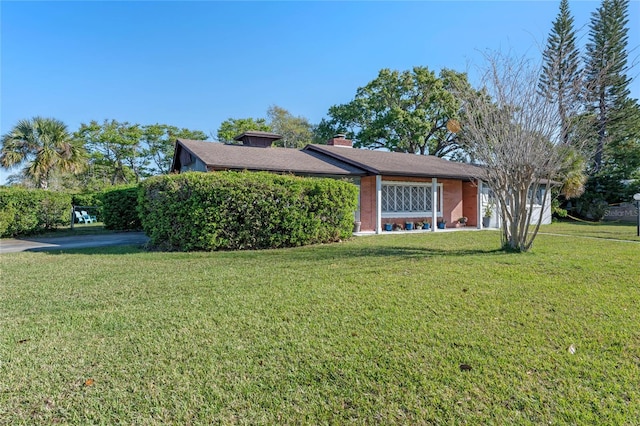 view of front of property featuring a front yard and a chimney