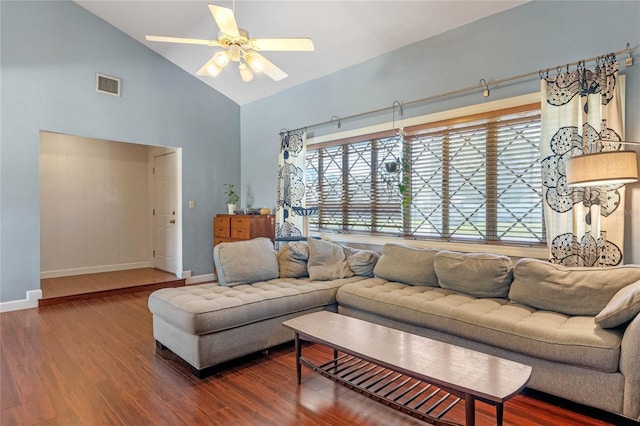 living area with wood finished floors, visible vents, and baseboards