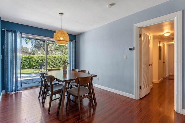 dining space with baseboards and dark wood-style floors