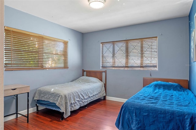 bedroom featuring baseboards and wood finished floors