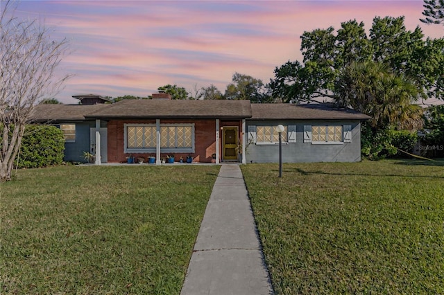 ranch-style home featuring a front yard