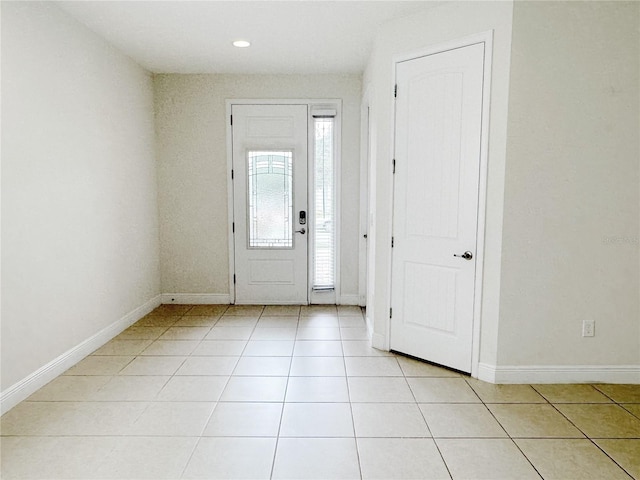 entrance foyer with light tile patterned floors and baseboards