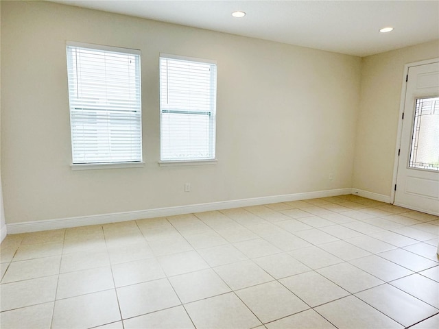 empty room featuring recessed lighting and baseboards