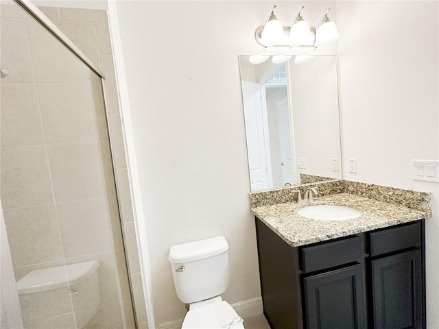 full bathroom with toilet, a stall shower, and vanity