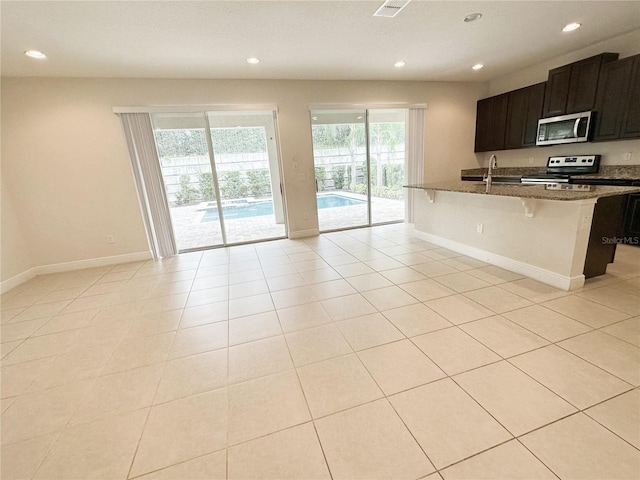 kitchen with recessed lighting, stainless steel appliances, and a sink