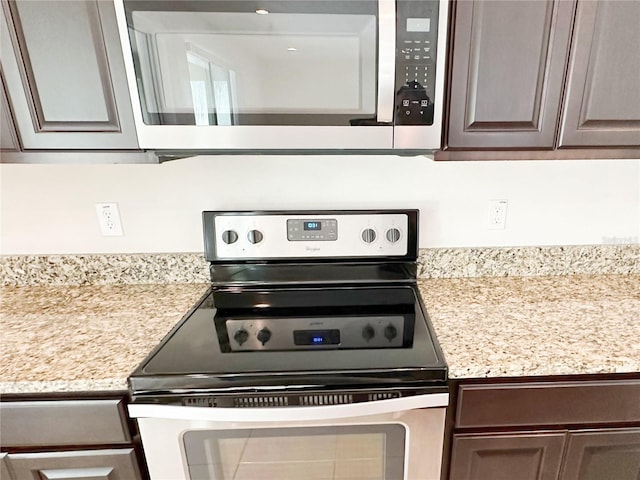 kitchen featuring dark brown cabinets and appliances with stainless steel finishes