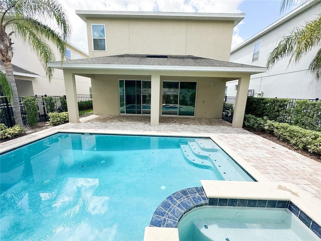 back of house with a patio area, stucco siding, and a shingled roof